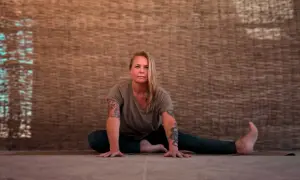 Kvinna i yinyoga-position med armarna utsträckta. Kan uppleva biverkningar som djup avslappning.